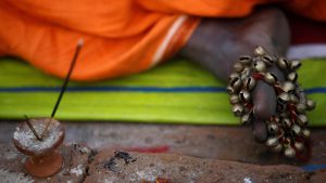 A musical instrument is pictured on the feet of a Hindu holy man, or sadhu, as he sits at the premises of Pashupatinath Temple during the Shivaratri festival in Kathmandu, Nepal February 24, 2017