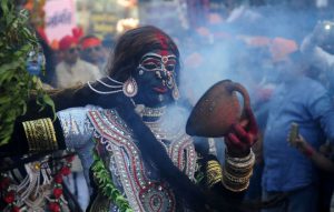 An artist dressed as the Hindu goddess Kali performs during a religious procession to mark the Hindu festival of Maha Shivratri in Allahabad