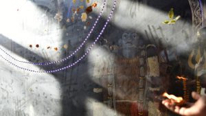 An idol of Shiva as seen from behind a screen at a temple in Old Delhi