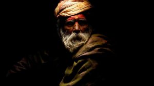 Light illuminates a Hindu holy man, or sadhu, as he sits at the premises of Pashupatinath Temple during the Shivaratri festival in Kathmandu, Nepal February 24, 2017