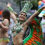 Performers take part in the annual street parade celebrations .