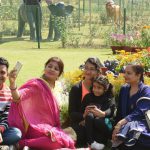 Tourists basking in the sun at Rose Garden