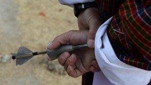 A Bhutanese villager prepares to throw a dart as he takes part in a ‘Turung Game’ during the celebration of ‘Losar’ at Paro