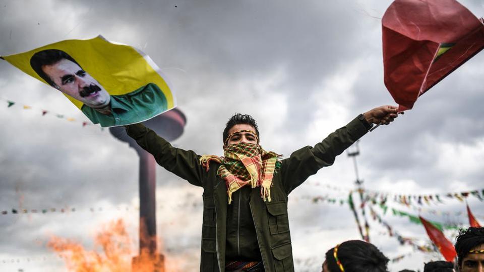 A Kurdish boy waves flags with a picture of jailed Kurdish leader Abdullah Ocalan during the celebrations of Newroz
