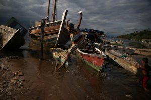 A boy jumps from a boat at the Bancarios beach, ahead of World Water Day, in the Guanabara bay in Rio de Janeiro, Brazil
