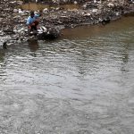 A man fishes along a river bank in Jakarta on March 21, 2017, on the eve of World Water Day. International World Water Day is marked annually on March 22 to focus global attention on the importance of water