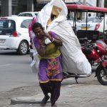 A rag picker picks up scrap on International Women’s Day in Amritsar on March 8, 2017