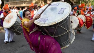 A woman beats a drum to welcome the new year at a rally in Jogeshwari,Mumbai