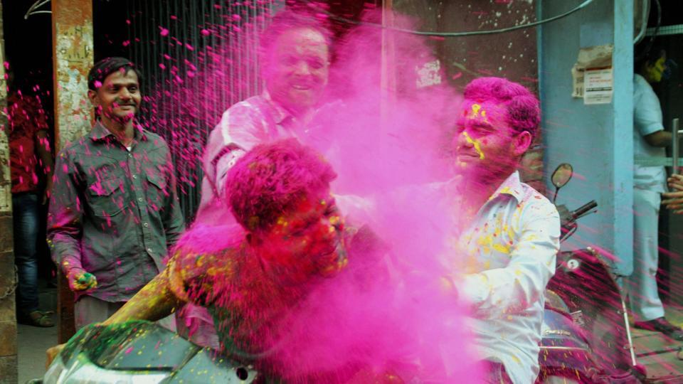 College students play with powdered colour as they take part in Holi festival celebrations in Lucknow