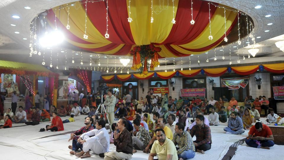 Devotees listening to religious songs at Durga Mata temple in Ludhiana