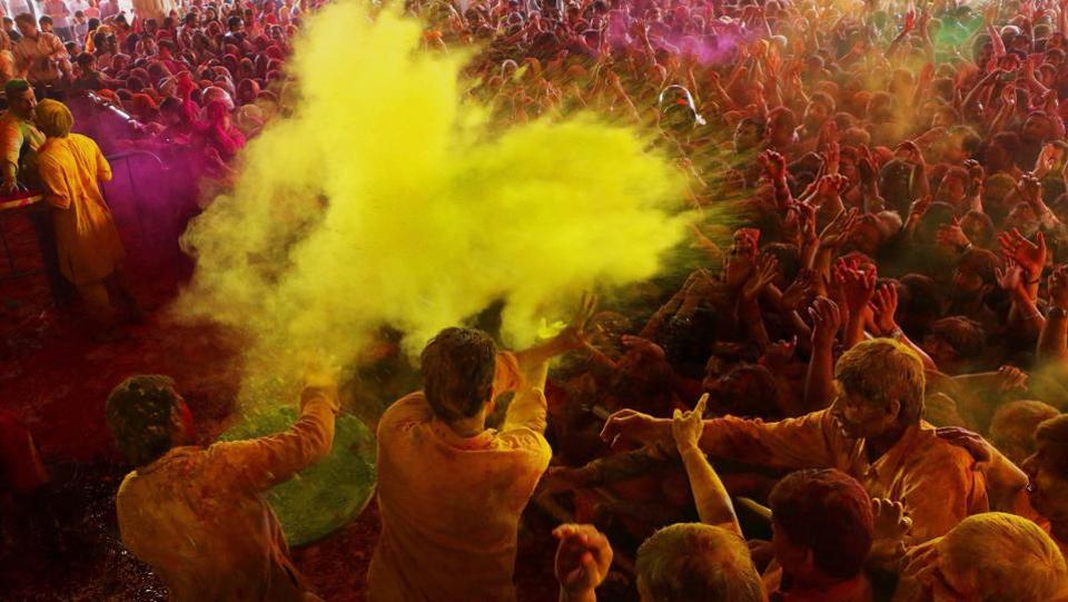 Devotees playing with colours at historical Govind Dev Ji temple in Jaipur . The streets and lanes across most of India have turned into a large playground where people of all faiths throw colored powder and water at each other