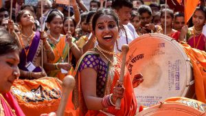Happy faces all around as women dressed in traditional Maharashtrian attires play drums at Girgaum