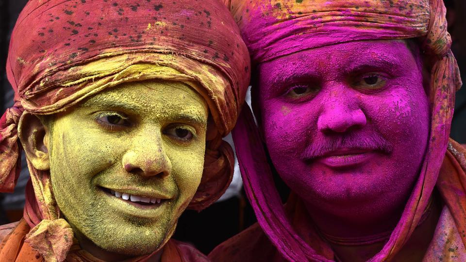 Indian villagers smear colours during the Lathmar Holi festival at the Nandji Temple in Nandgaon, some 120 kms from New Delhi