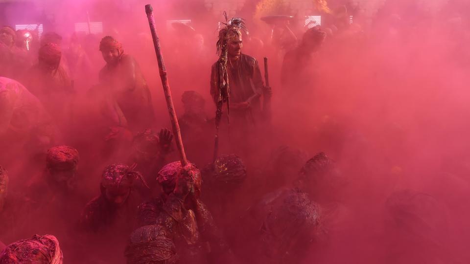 Indian villagers smear themselves with colours during the Lathmar Holi festival at the Nandji Temple in Nandgaon, some 120 kms from New Delhi. The women of Nandgaon, the home town of Hindu God Krishna, attack the men from Barsana, the legendary home town of Radha, consort of Hindu God Krishna, with wooden sticks in response to their efforts to put color on them, reciprocating acts performed yesterday in Barsana between the women of that village with the men of Nandgaon as they observe the Lathmar Holi festival