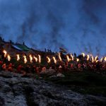 Iraqi Kurdish people carry fire torches up a mountain, as they celebrate Newroz Day, a festival marking their spring and new year, in the town of Akra, Iraq