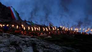 Iraqi Kurdish people carry fire torches up a mountain, as they celebrate Newroz Day, a festival marking their spring and new year, in the town of Akra, Iraq
