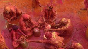 Men from the village of Nandgaon throw coloured powder at each other before joining a procession for the Lathmar Holi festival at the legendary hometown of Radha, consort of Hindu God Krishna, in Barsana