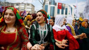 People gesture during a gathering celebrating Newroz, which marks the arrival of spring and the new year, in Istanbul, Turkey