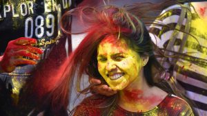 People smear colored powder on the face of a girl as they celebrate Hol in New Delhi. Celebrants light bonfires, throw colourful powder called gulal, eat sweets, and dance to traditional folk music