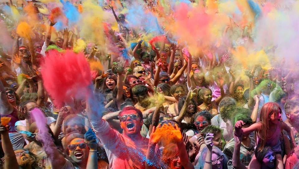 People throw coloured powder during the Holi festival in Santa Coloma de Gramenet, near Barcelona, Spain. The festival is fashioned after the Hindu spring festival Holi, which is mainly celebrated in the north and east of India.