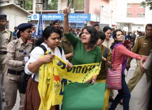 Policewomen move on students as they demonstrate outside the Ministry of Women and Child Development in New Delhi on March 8, 2017, on International Women’s Day