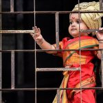 This cute picture in red held on to her window to see a procession celebrating 'Gudhi Padwa' or the Maharashtrian New Year from her balcony in Girgaum