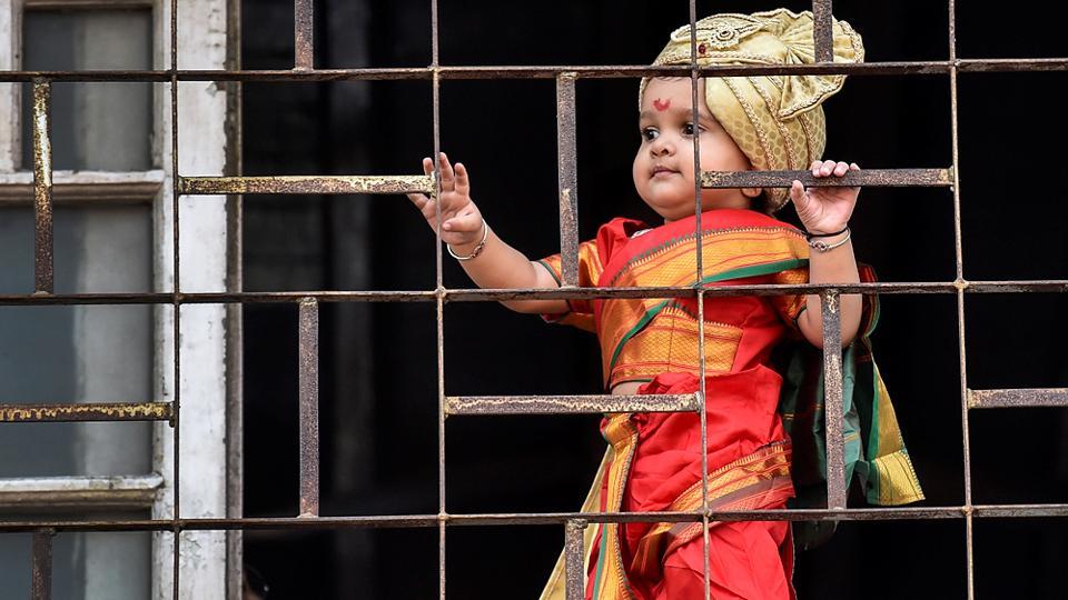 This cute picture in red held on to her window to see a procession celebrating 'Gudhi Padwa' or the Maharashtrian New Year from her balcony in Girgaum
