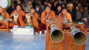 Tibetan Buddhist monks blow ceremonial horns during a special morning prayer session on the third day of ‘Losar’, or Tibetan New Year, in Dharamsala