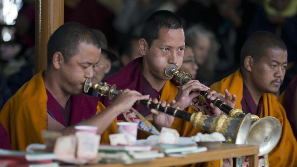 Tibetan Buddhist monks play ceremonial horns during a special prayer ceremony on the third day of the Tibetan New Year called 'Losar' in Dharmsala