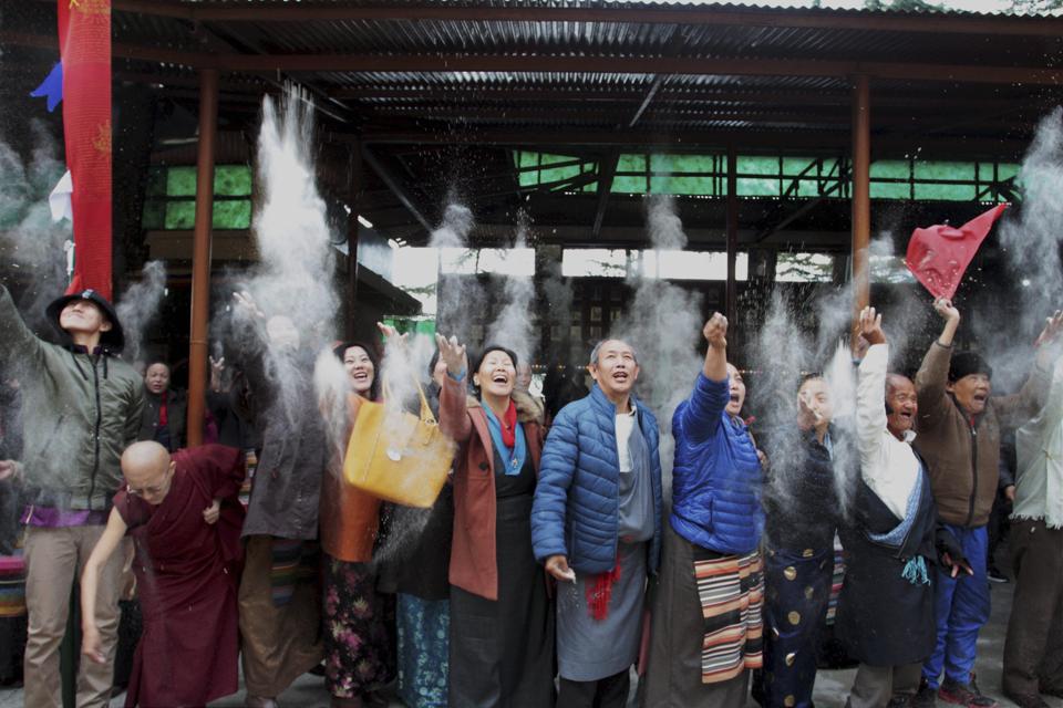 Tibetans in exile throwing barley flour in air on the 3rd day of Tibetan New Year ‘Losar’ at Mcleodganj in Dharamshala