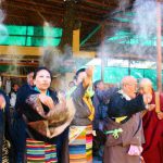 Tibetans throw white flour powder in air during a prayer session as part of ‘Losar’ celebration