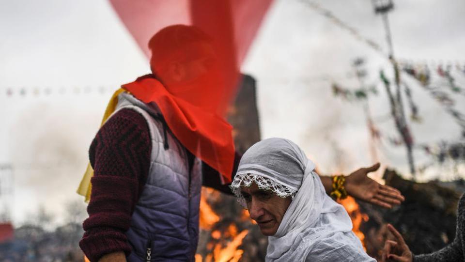 Turkish Kurds gather around a bonfire for Newroz celebrations for the new year in Diyarbakir, southeastern Turkey