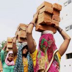 Women carry bricks at a construction site on International Women’s Day in Allahabad on March 8, 2017