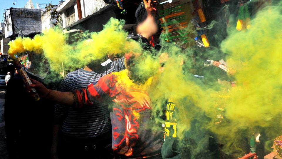 Youth play with water and coloured powder during Holi festival celebrations in Jammu