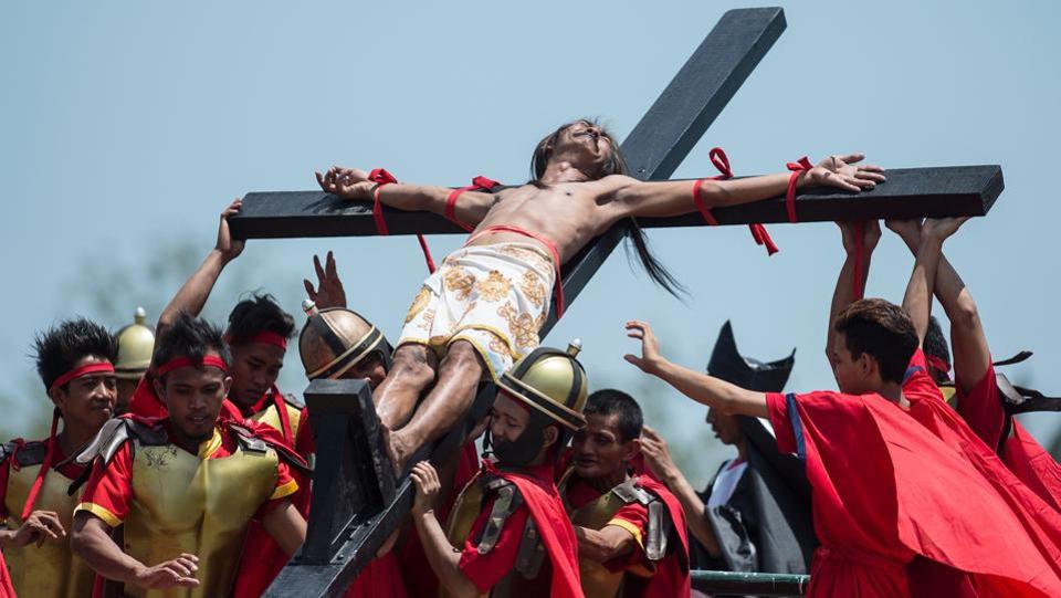 A Philippine Christian devotee reacts in pain while nailed to a cross during a re-enactment of the Crucifixion of Christ. While some say ‘good’ means holy, others say that it is a modification of ‘God Friday.’