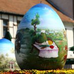 A child looks at a two-metre-high Easter eggs painted in the traditional naive art style in Koprivnica, Croatia, April 9