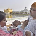 A couple gives water to an infant in the parikarma (circumambulation) of the Golden Temple in Amritsar on Friday, April 21 2017