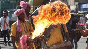 A fire-eater from Punjab performs to the heady beat of the traditional dhol. Participants from various states danced, sang and performed as they walked the 5km long rally