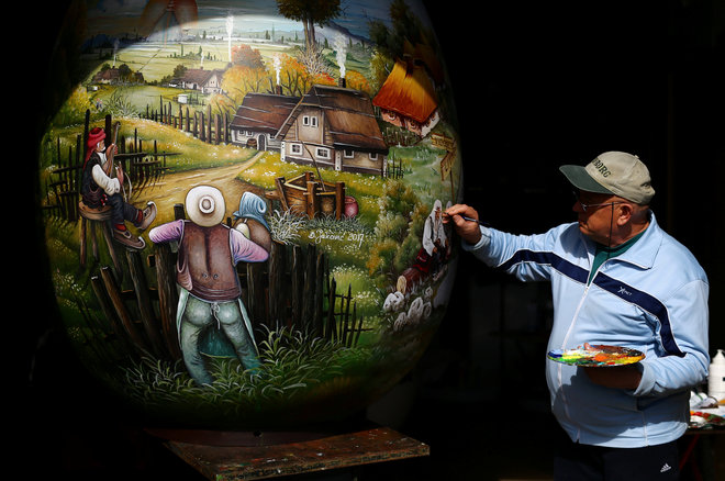 A local artist paints a two-metre-high Easter egg in the traditional naive art style in Koprivnica, Croatia, March 9, 2017. The project, which started ten years ago, involves painters decorating two-metre-tall polyester eggs, which are then sent to cities in the country and abroad to be displayed in public squares in time for Easter festivities