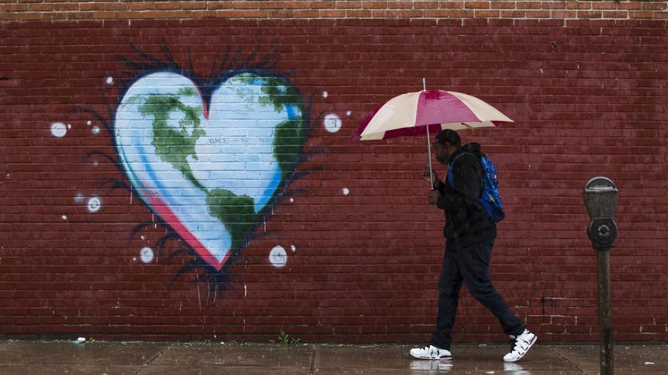 A man walks past a mural the day before Earth Day, in Philadelphia.