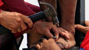 A penitent’s feet is being nailed on a wooden cross during a Good Friday crucifixion re-enactment in Cutud village, Pampanga province, north of Manila, Philippines. Good Friday is observed as a public holiday in various countries such as India, Canada, the UK, Germany, Australia, Bermuda, Brazil, Finland, Malta, Mexico, New Zealand, Singapore and Sweden among others