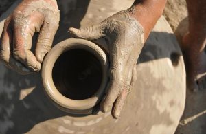 A potter working on earthen water coolers in Mansoorwal village on the outskirts of Kapurthala