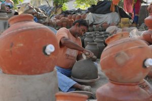 A potter working on earthen water coolers in Mansoorwal village on the outskirts of Kapurthala