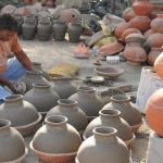 A potter working on earthen water coolers in Mansoorwal village on the outskirts of Kapurthala