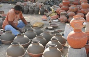 A potter working on earthen water coolers in Mansoorwal village on the outskirts of Kapurthala