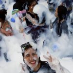 A reveller reacts at a foam party during Songkran Festival celebrations. The festival is by far the most important event of the year for the Thai people