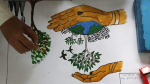 A school child draws a tree promoting conservation of the planet on world Earth Day at the Chandra Shekhar Azad Park in Allahabad.