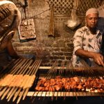 A vendor sells kebabs to visitors and pilgrims visiting the Nizamuddin dargah
