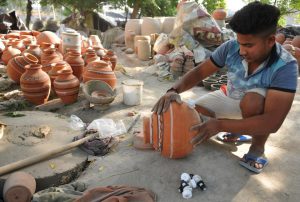 A worker checking on earthen water coolers at a potter’s establishment in Mansoorwal village on the outskirts of Kapurthala