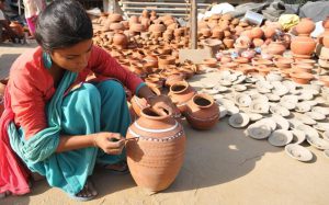 A worker painting earthen water coolers in Mansoorwal village on the outskirts of Kapurthala